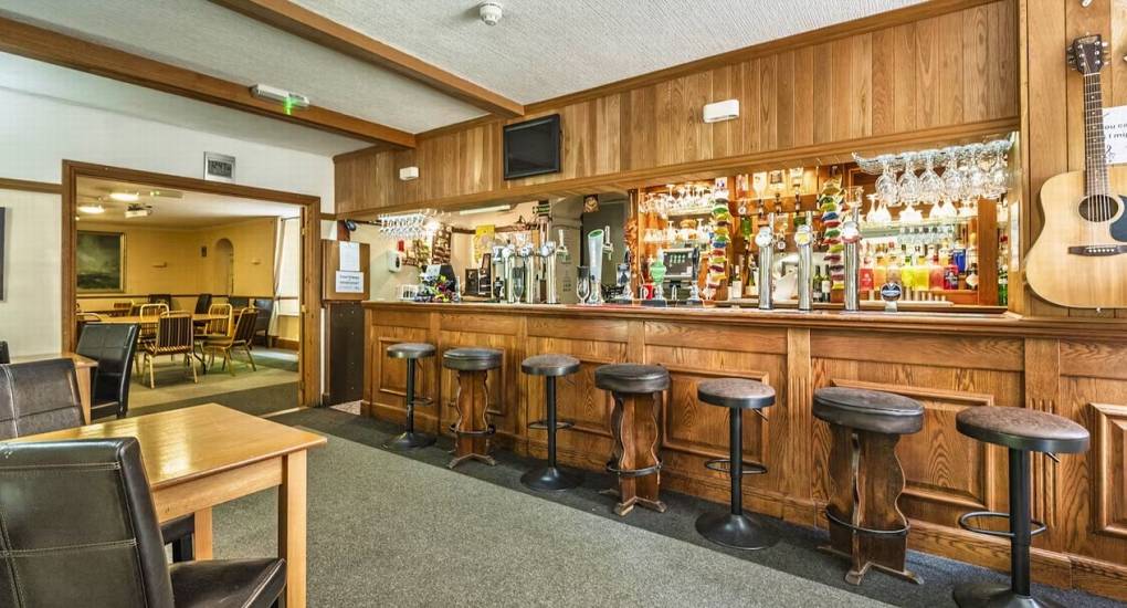The exclusive private bar at River View Lodge, with bar stools and a seated area, is the ideal space for a hen party.