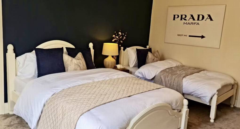 A spacious and modern bedroom at Rivers Countryside Mansion with a double and single bed, ideal for a Herefordshire hen party.
