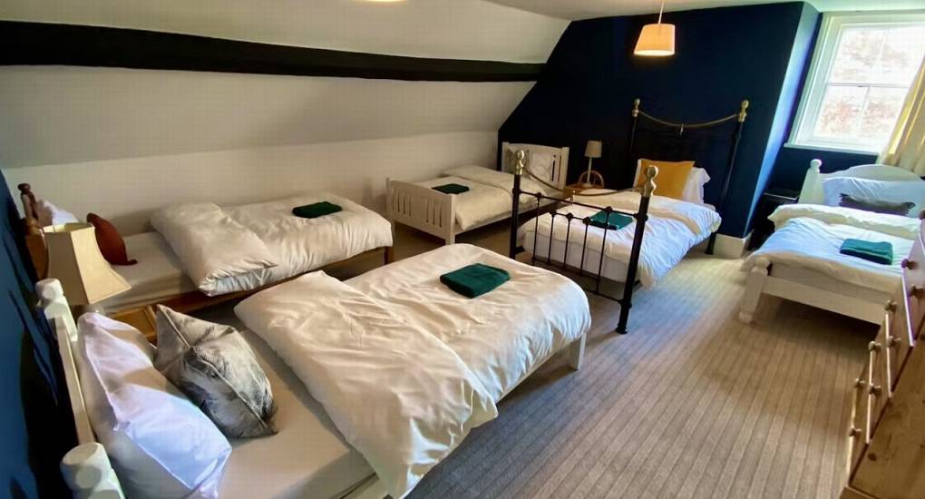 A dorm-style bedroom at Rivers Countryside Mansion with multiple beds, ideal for large hen parties and groups of up to 36.