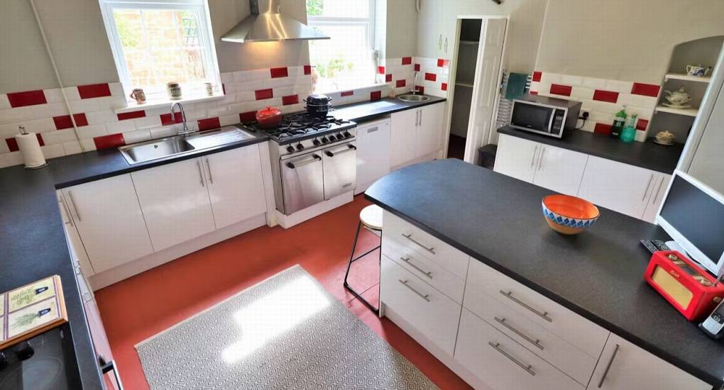A view of the kitchen island and spacious countertops at this Herefordshire hen party mansion, perfect for communal cooking.