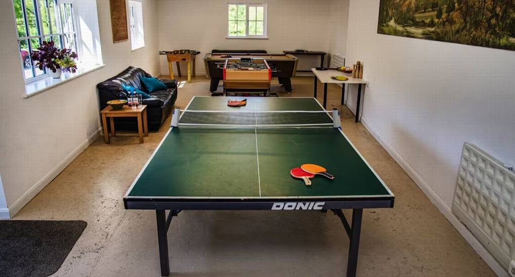 The spacious games room at Ross Lodge Gloucestershire featuring a pool table, table tennis, and table football, one of the key entertainment features for this hen do accommodation.