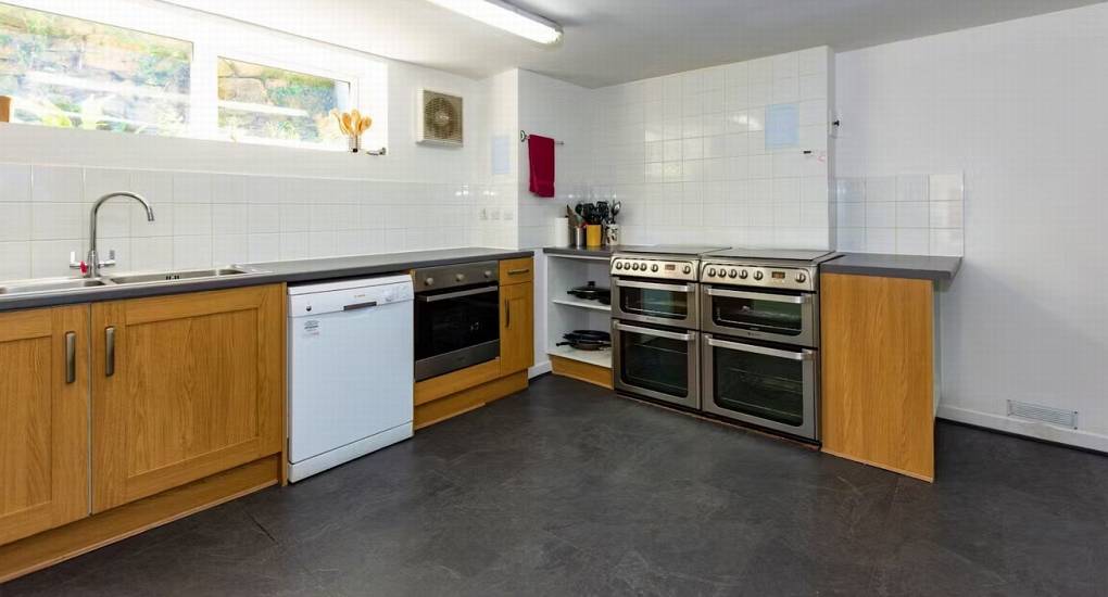 A second view of the kitchen area at Ross Lodge Gloucestershire, highlighting the double ovens and cooking amenities for this Gloucestershire hen do accommodation.