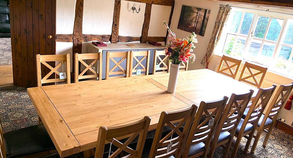 Large dining room table set up for a murder mystery evening
