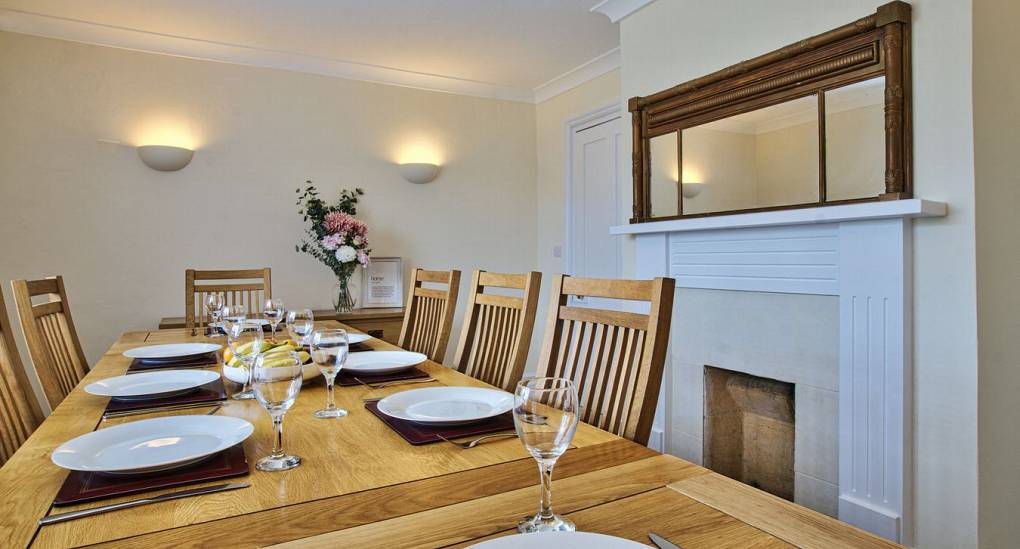 Wooden dining room table with fire place