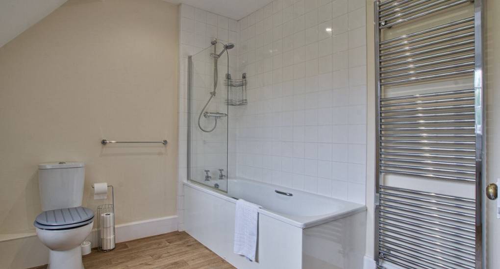 Massive towel rail in bathroom with shower over bath