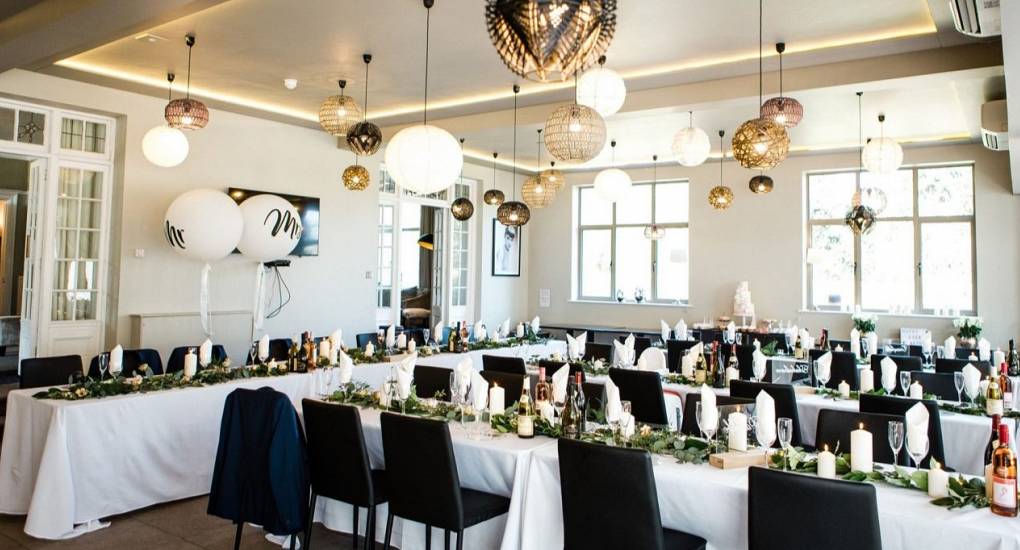 Large dining area with tables set for a wedding