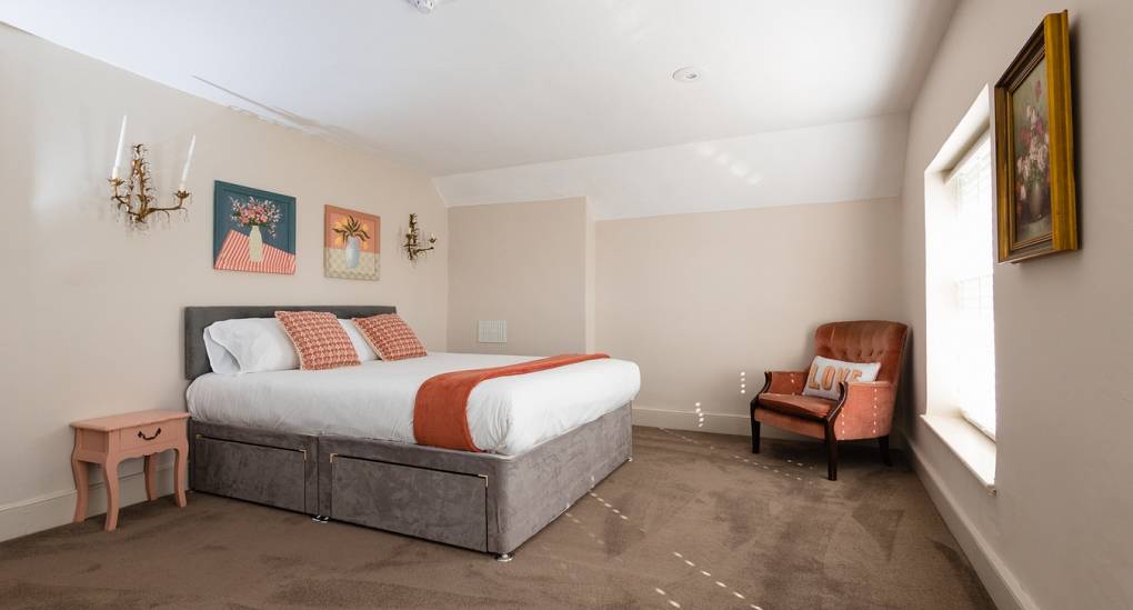 One of the nine bedrooms at the Grand Manor large party house with large king size bed