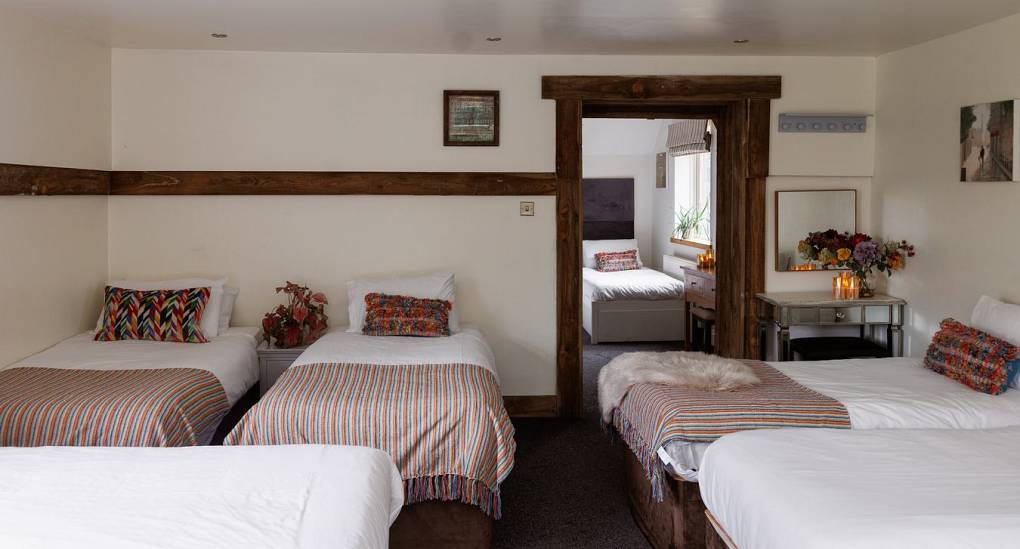 Five single beds in one bedroom