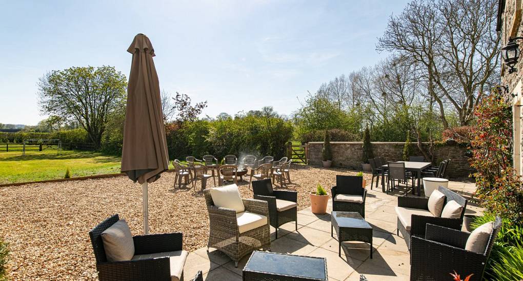 Long view of the garden seating and umbrella 