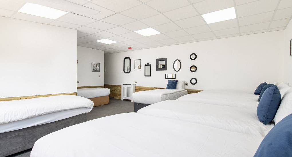 Multi bedded bedroom with pictures on the wall