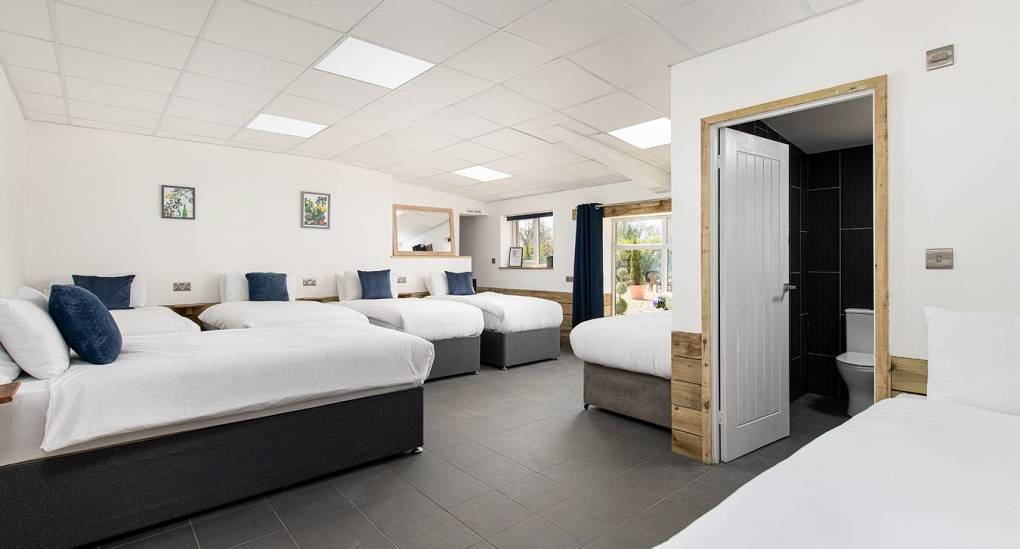 Bedroom with multiple beds and en suite bathroom 