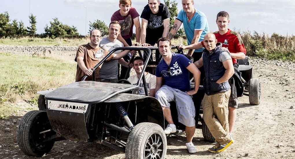 Stag do group pose for photo with a Rage Buggy