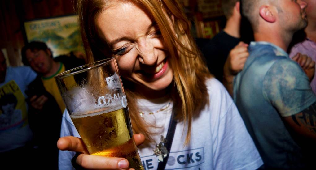 Young woman enjoys a drink on the guided bar crawl