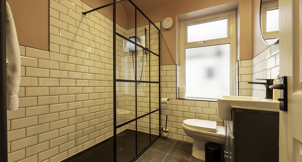 Pink walled walk in shower room