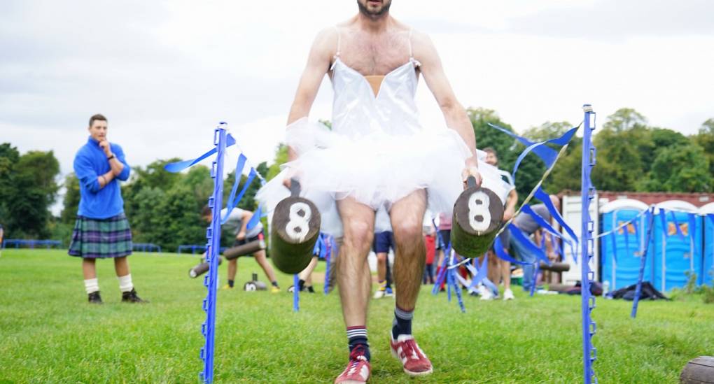Stag do in fancy dress enjoying the mini highland games