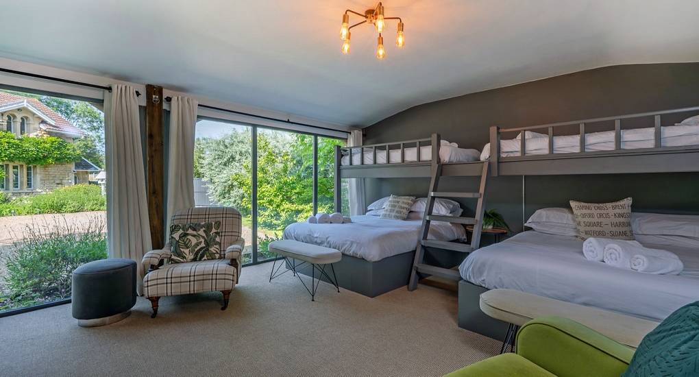 Bath hen weekend accommodation: Luxury garden cabin bedroom at Summerset House with double and single beds.