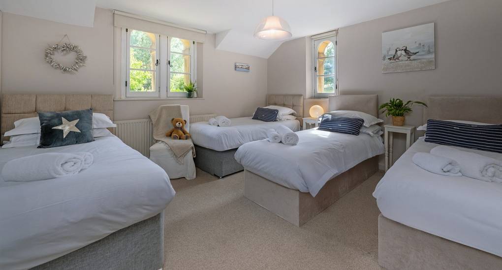 Bath hen party house: Bedroom 3 at Summerset House offering four single beds and bright, modern decor.