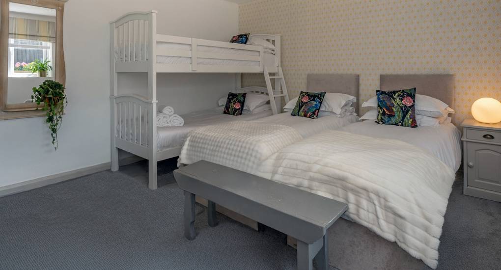 Large hen party house in Bath: Bedroom 2 at Summerset House with four comfortable single beds for group stays.