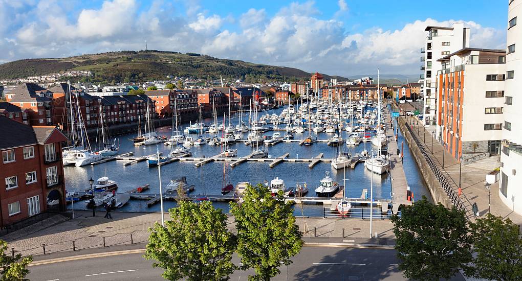 Yachts and boats docked at Swansea Marina with Kilvey Hill in the background, scenic backdrop for a Swansea stag do.