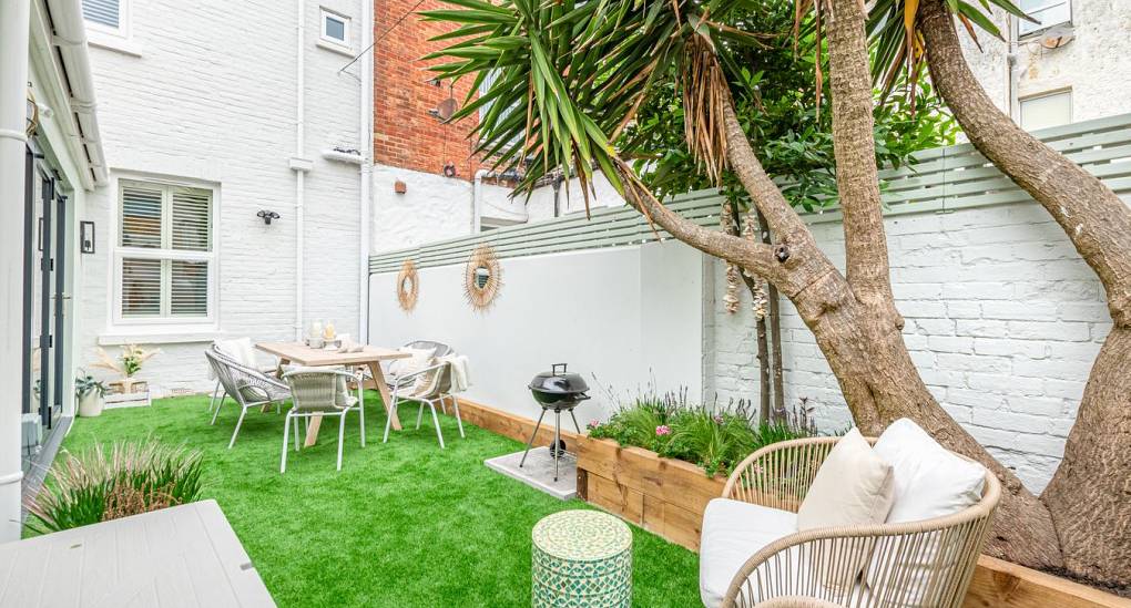 Private courtyard garden with hot tub at The Drift: Central Bournemouth hen do accommodation near the beach.