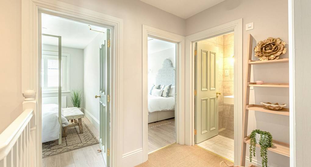 Spacious upstairs landing at The Drift: Luxury Bournemouth hen party house featuring stylish interiors and access to five group bedrooms.