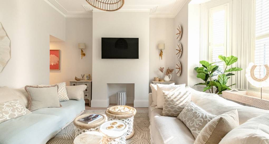 Bright social lounge at The Drift: Luxury Bournemouth hen party house with bay windows and comfortable seating for 14 guests.