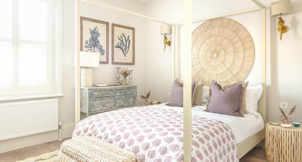 Modern bedroom interior at The Drift: Luxury hen accommodation in Bournemouth featuring bright bay windows.