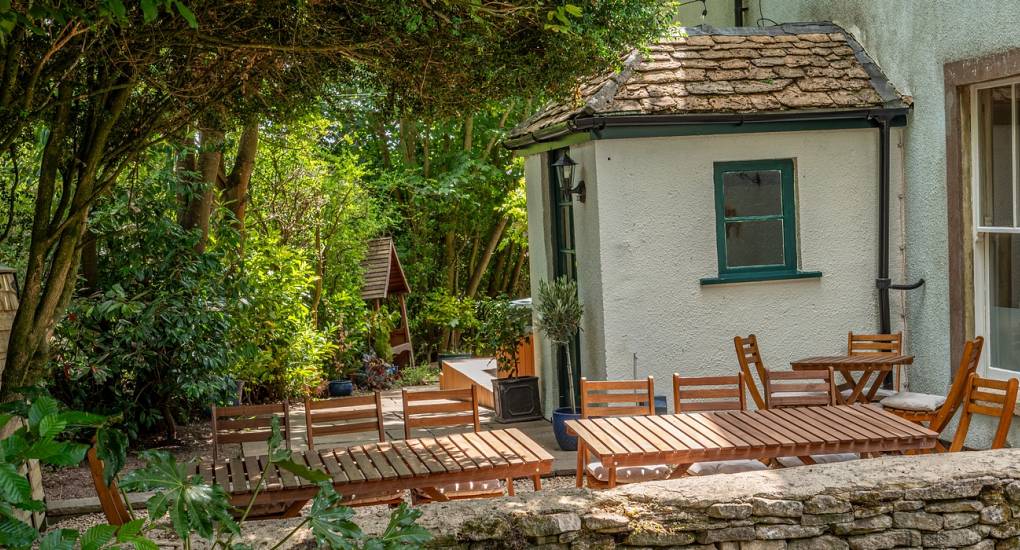 Garden area with furniture taken from over a low stone wall