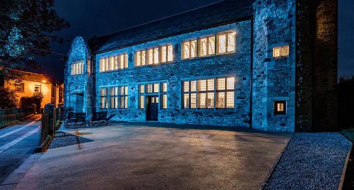 The front of the Grand Hall Lake District Party House at night