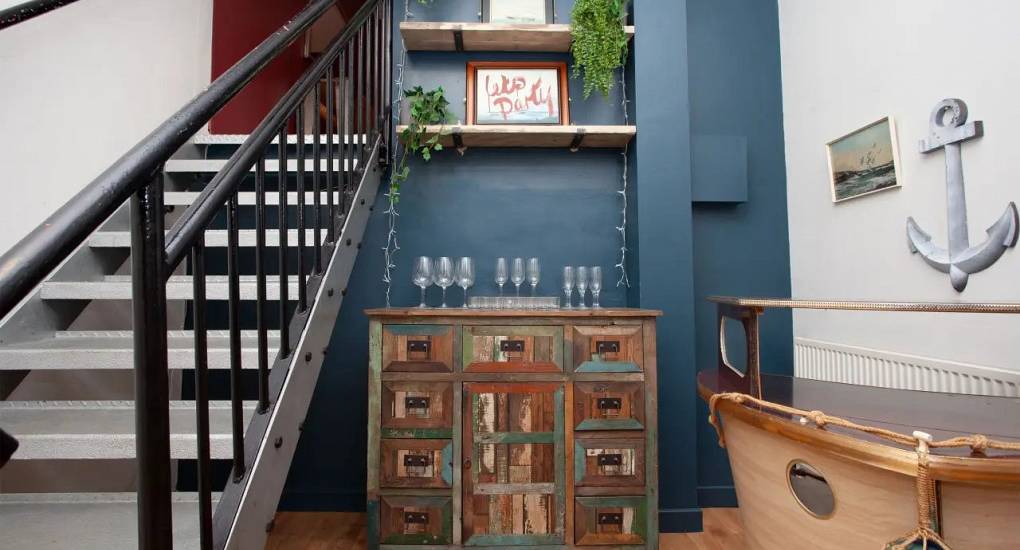 Cardiff stag accommodation hallway area with staircase and decorative side board