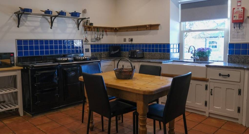 The kitchen area at the Swallow with small table and chairs