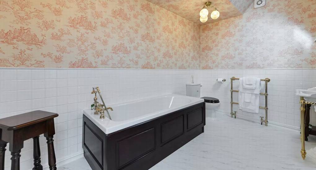 Modern en-suite bathroom with a bath at The Parsonage, a luxury Nottingham hen party house.