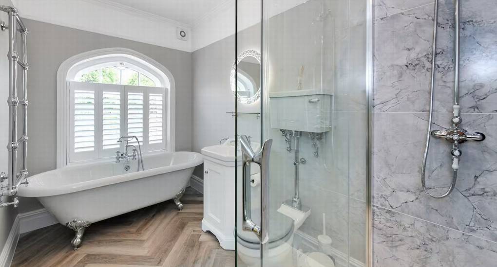 Contemporary en-suite bathroom with bath and shower at The Parsonage, a premier Nottingham hen party house.