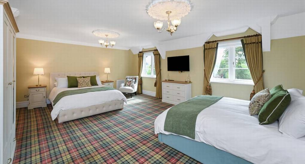 Spacious double bedroom with en-suite access at The Parsonage, a luxury Nottingham hen party house.