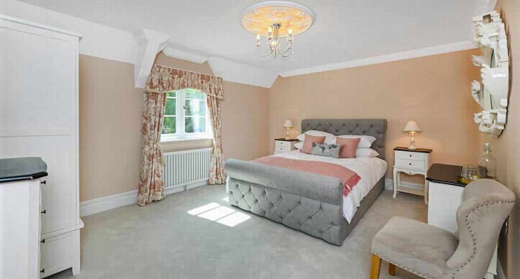 Elegant king-sized bedroom with private en-suite bathroom at The Parsonage, a luxury Nottingham hen party house.