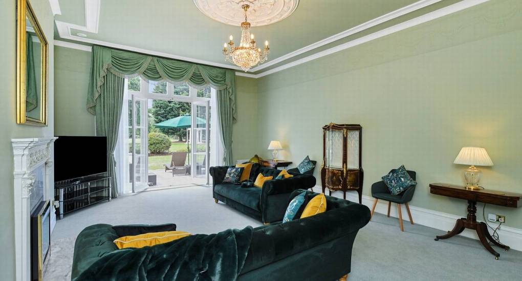 Stunningly decorated living room with plenty of seating for groups at The Parsonage, a luxury Nottingham hen party house.