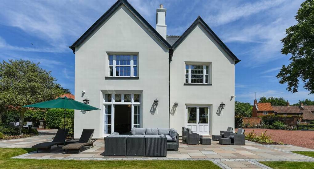 Modern patio seating and rear view of The Parsonage, a luxury Nottingham hen party house with private grounds.