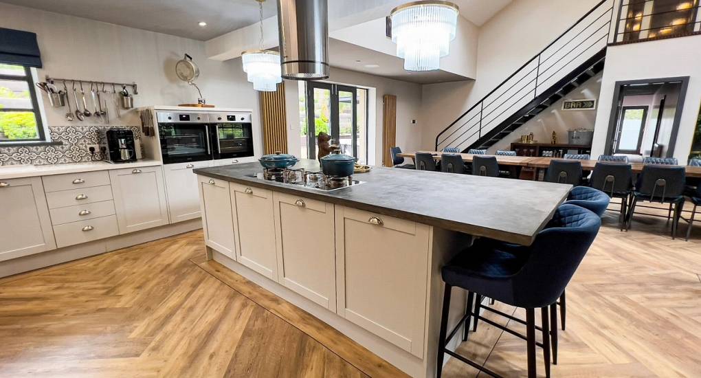 A close-up of the modern kitchen island and breakfast bar at The Plush, fully equipped with professional appliances—ideal for hosting cheeky butlers or a cocktail masterclass during a Newcastle hen do.