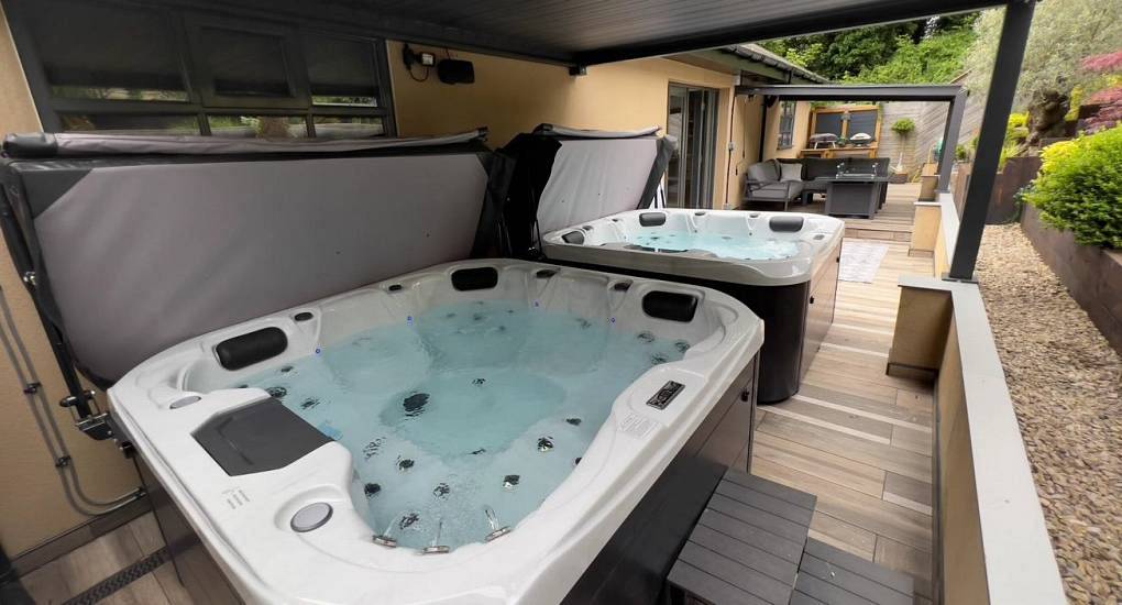 The grand Garden Oasis at The Plush, a luxury Newcastle hen house with two side-by-side hot tubs, mood lighting, and firepit near Tynemouth beach.