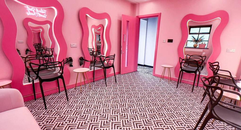 The incredible pink 'Powder Room' at The Plush, a luxury Newcastle hen house, featuring a salon-style dressing area with multiple LED mirror stations and professional hair dryers.