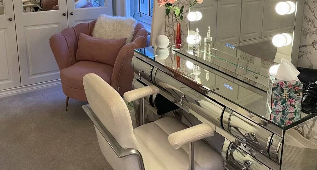 A dedicated makeup station with lights and mirror in one of the bedrooms at The Sash House, ideal for getting ready for a hen party.