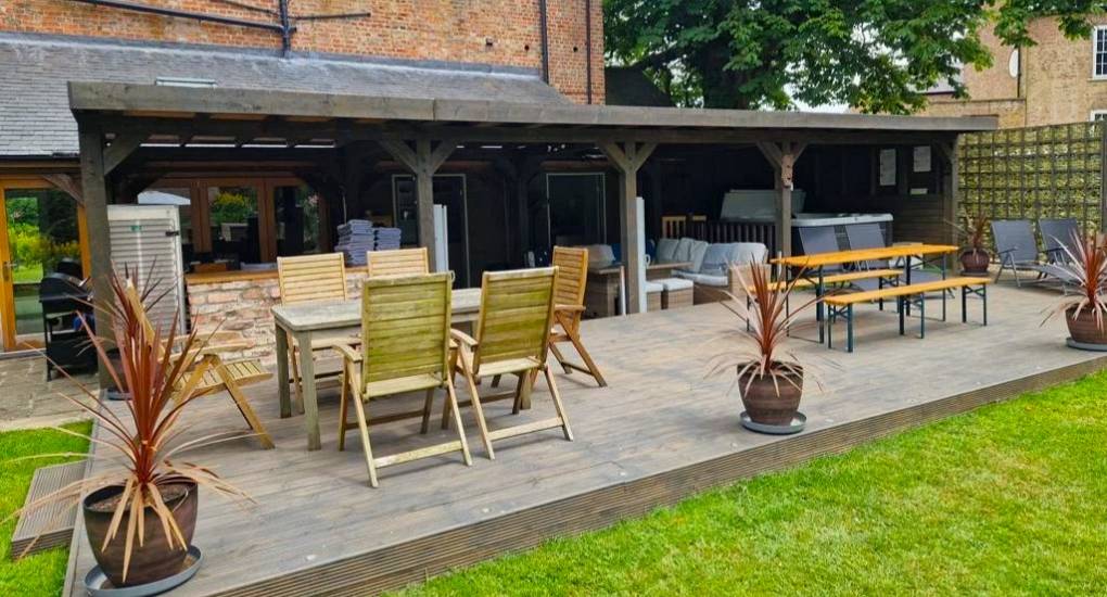 Garden view of the decking and the outside area with the grounds of the Stables York