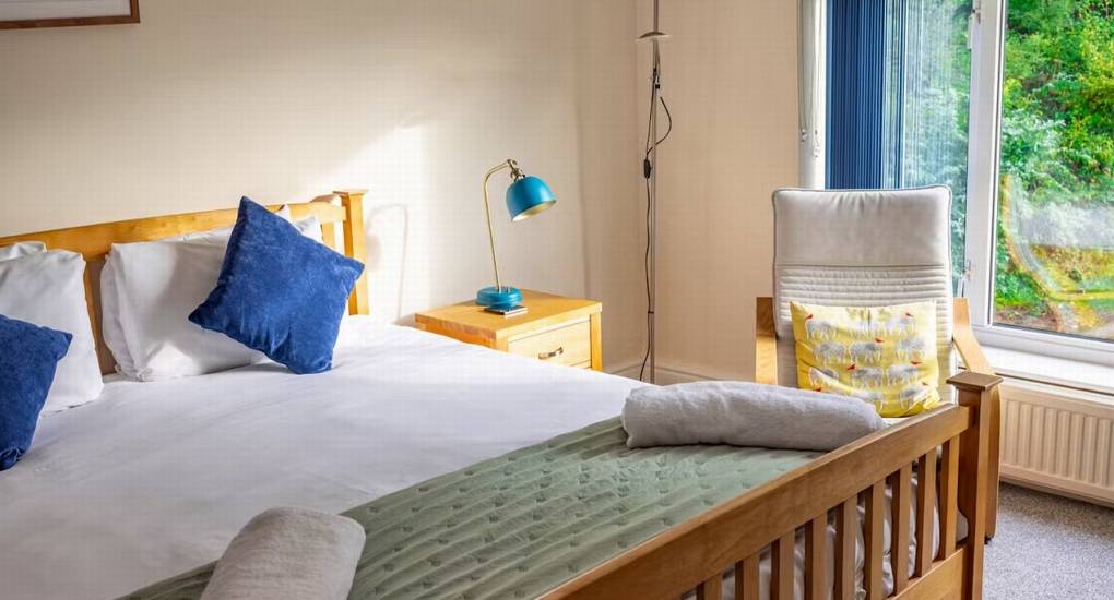 	A bright and airy double bedroom at White Horse House with a view of the woods, providing quality Herefordshire hen weekend accommodation for groups of 30.