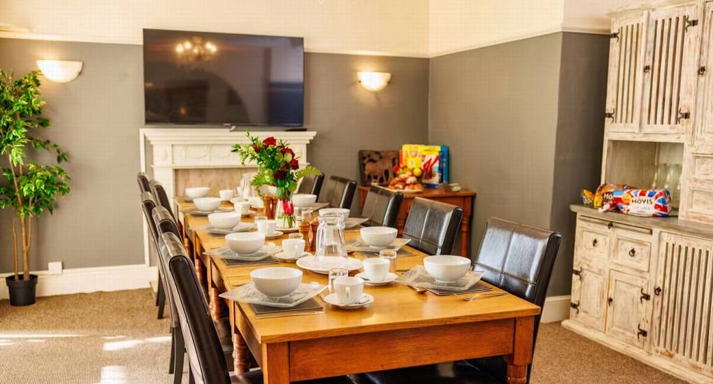 The spacious dining room at White Horse House, featuring a long table set for your group, perfect for hen weekend accommodation in Herefordshire that sleeps 30 guests.