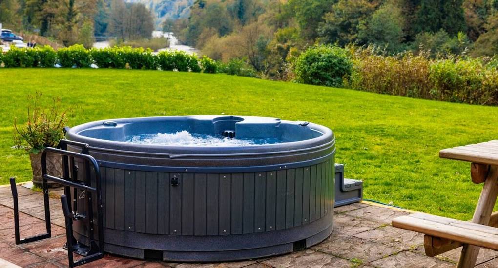 The inviting hot tub at White Horse House, set in a beautiful garden overlooking the River Wye, perfect for relaxing hen weekend accommodation in Herefordshire that sleeps 30.
