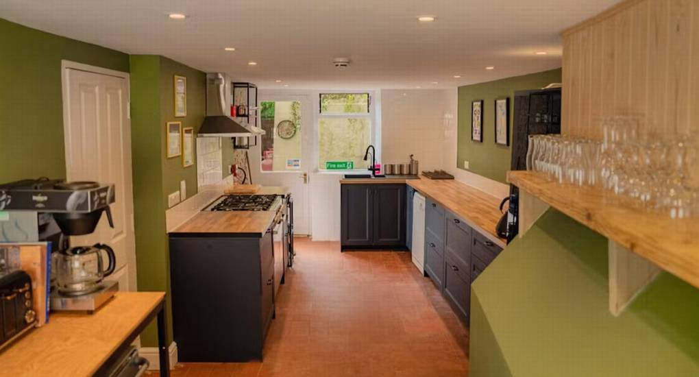 The spacious, well-equipped kitchen at The Wye House with a large range cooker and ample work space, perfect for catering for a large Herefordshire hen party group that sleeps 22.