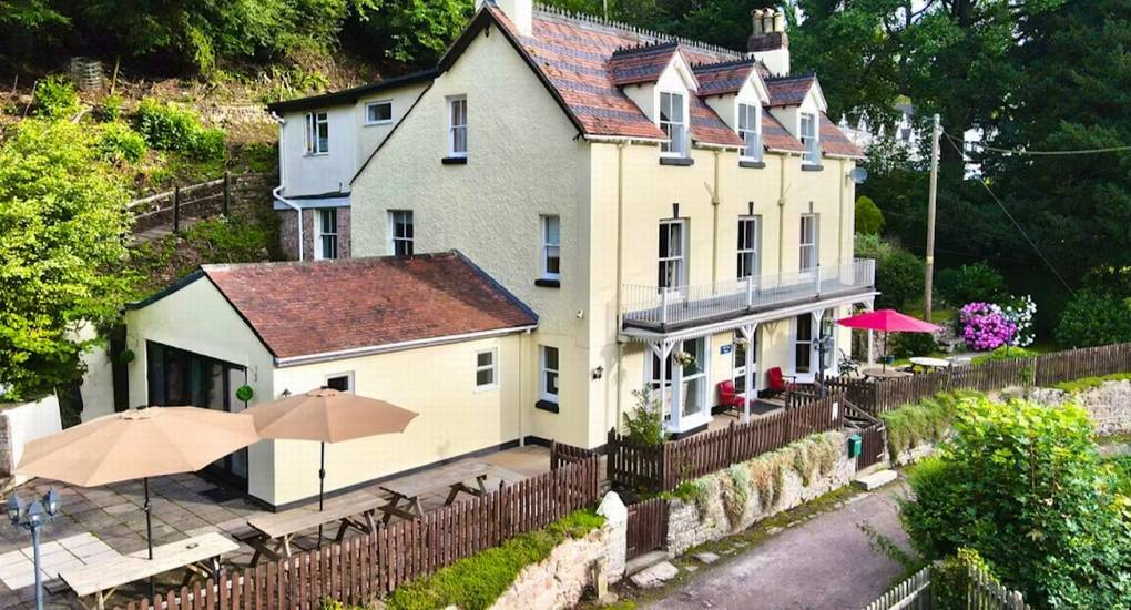 The magnificent exterior view of The Wye House from the front lawn, showcasing the large scale and traditional architecture of this Herefordshire hen party house.