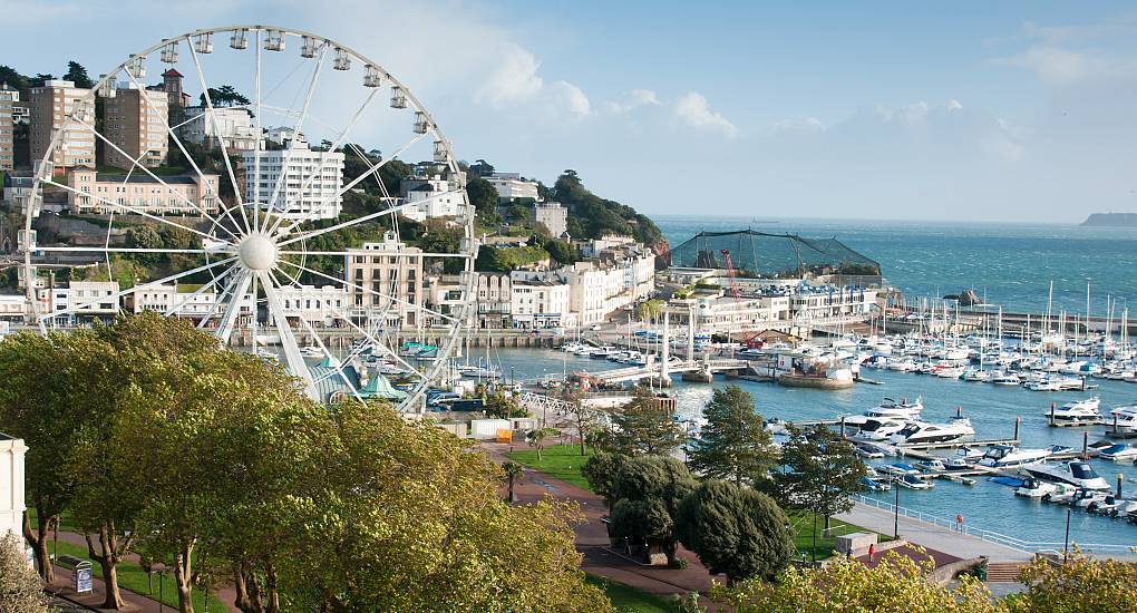 English Riviera Wheel and boats moored at Torquay Harbour, coastal resort backdrop for a Torquay hen do.