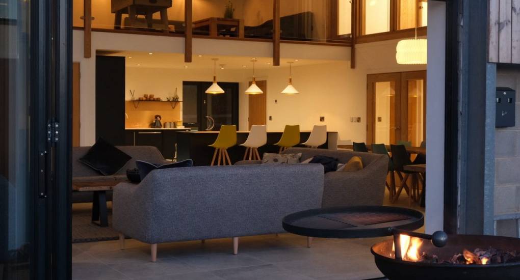Bi-fold doors connecting the lounge and patio at Tree View Hen Party House