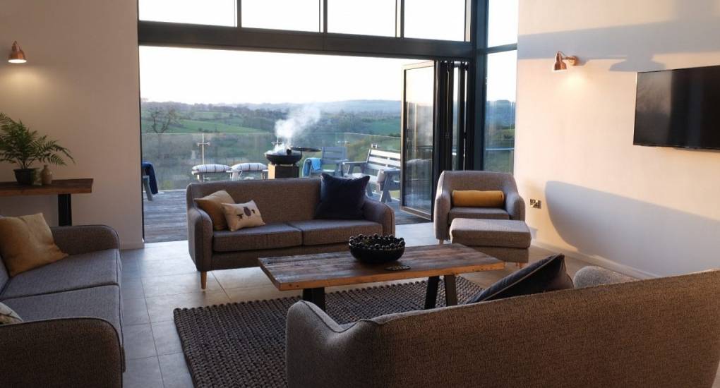 Bright lounge area with terrace access at Tree View Peak District accommodation